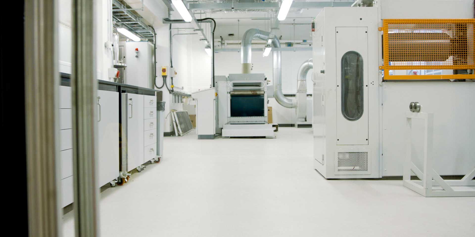 A pilot-scale nonwovens manufacturing facility housing processing machinery and ventilation systems.