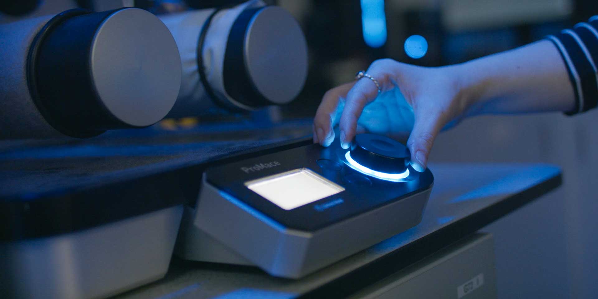 A close-up of a digital testing control console (ProMace) used for precision material analysis.